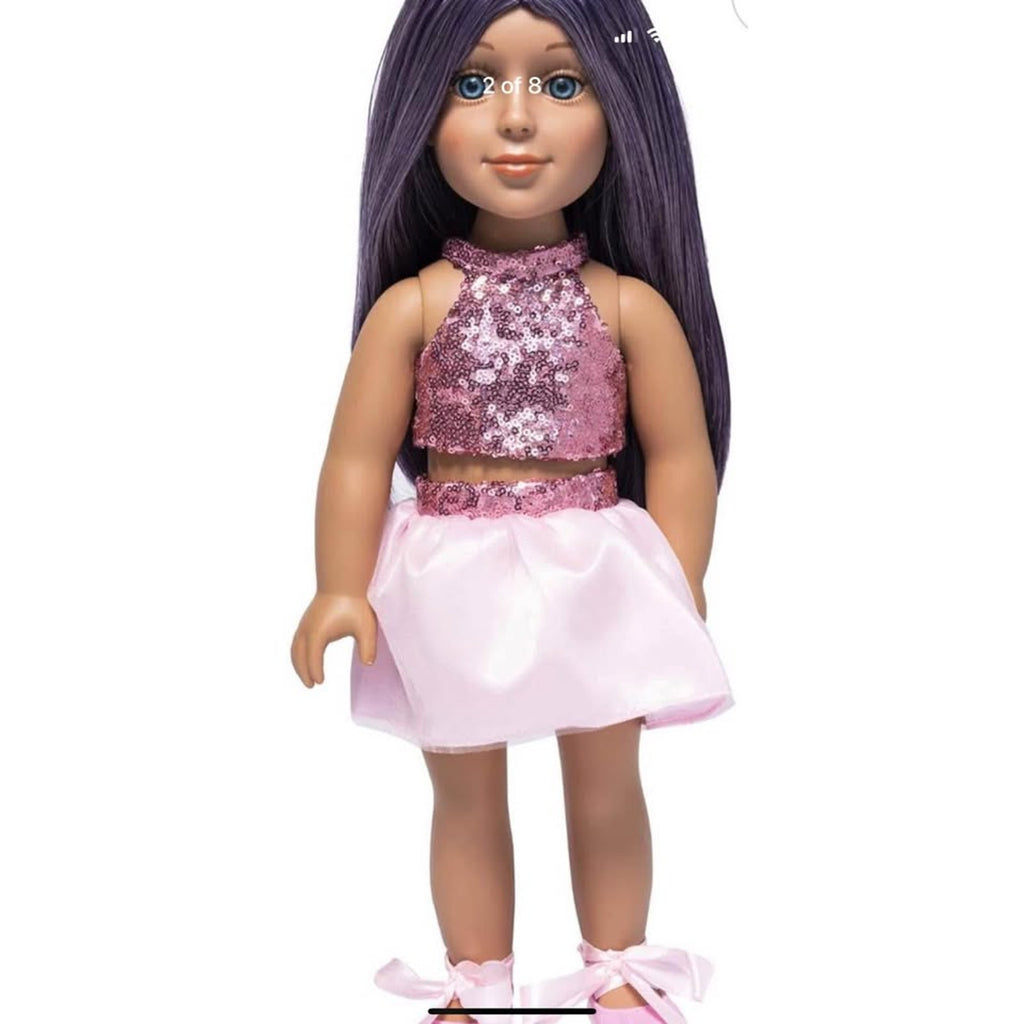 Doll wearing a pink sequined top and skirt on a white background